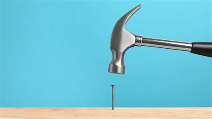 a white hammer on a gray background